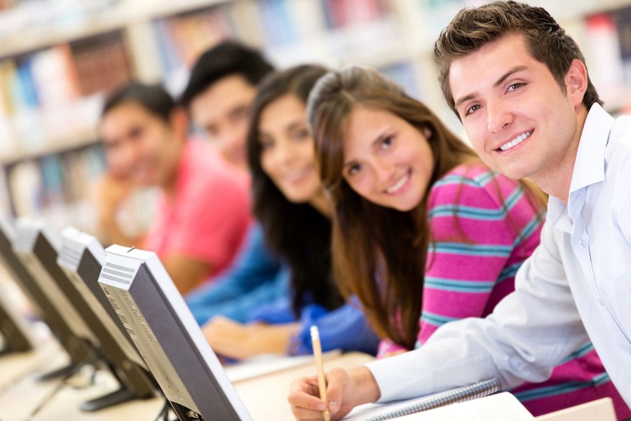 group of students studying with computers