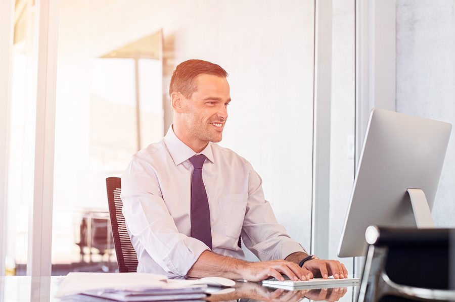 Businessman taking DISC Assessments at computer